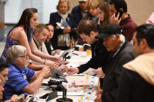 Poll workers assist voters waiting in line to cast their ballot during the presidential primary vote in Glendale, on Super Tuesday, March 3, 2020. (ROBYN BECK/AFP via Getty Images)