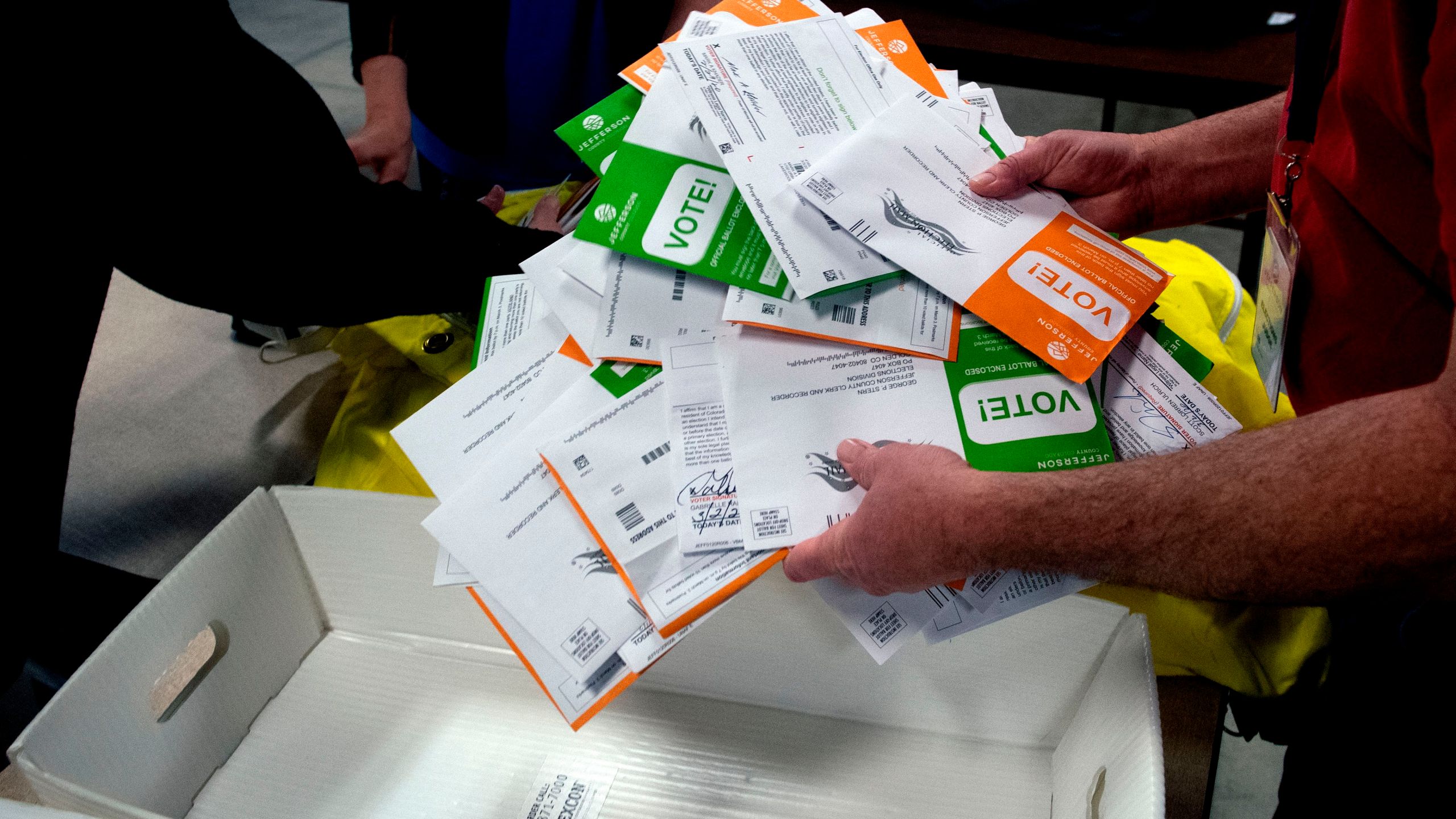 Election judges sort ballots in Golden, Colorado, on March 3, 2020. (Credit: Jason Connolly / AFP / Getty Images)