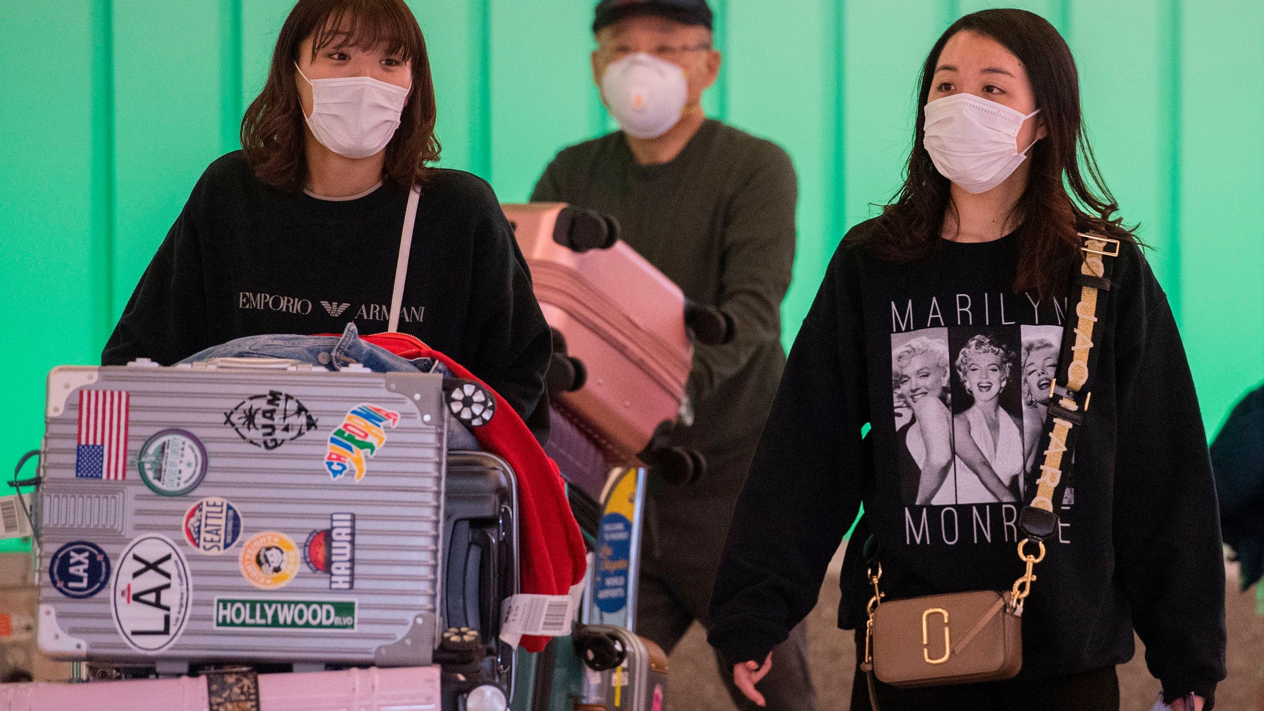 Passengers wear face masks to protect against the COVID-19 (Coronavirus) after arriving at Los Angeles International Airport in Los Angeles on March 5, 2020.(MARK RALSTON/AFP via Getty Images)