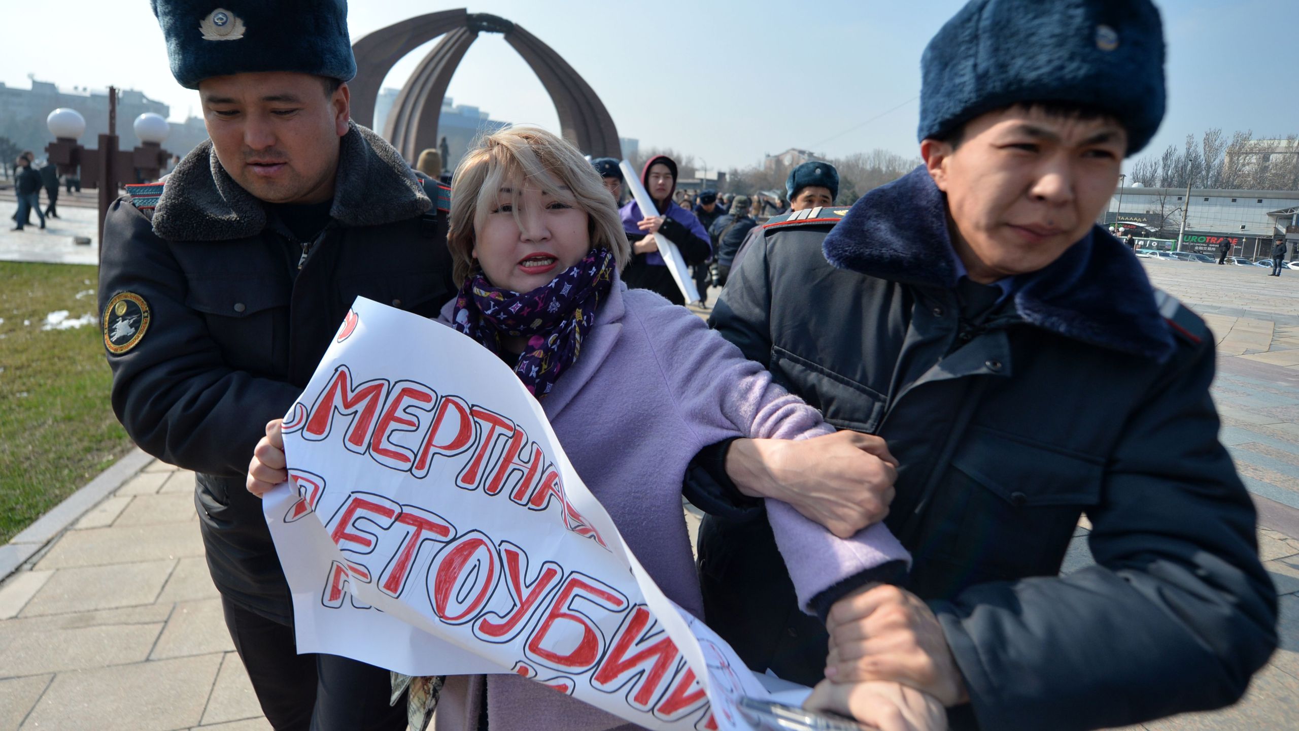 Kyrgyz police arrest a woman protesting against gender-based violence to mark International Women's Day in Bishkek on March 8, 2020. (VYACHESLAV OSELEDKO/AFP via Getty Images)