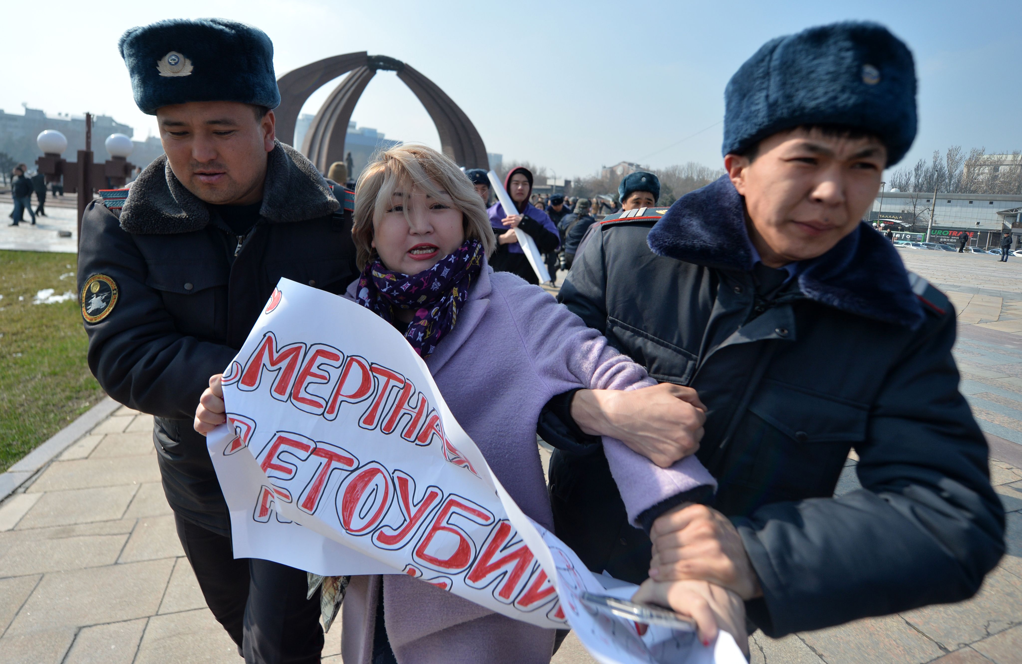 Kyrgyz police arrest a woman protesting against gender-based violence to mark International Women's Day in Bishkek on March 8, 2020. (VYACHESLAV OSELEDKO/AFP via Getty Images)