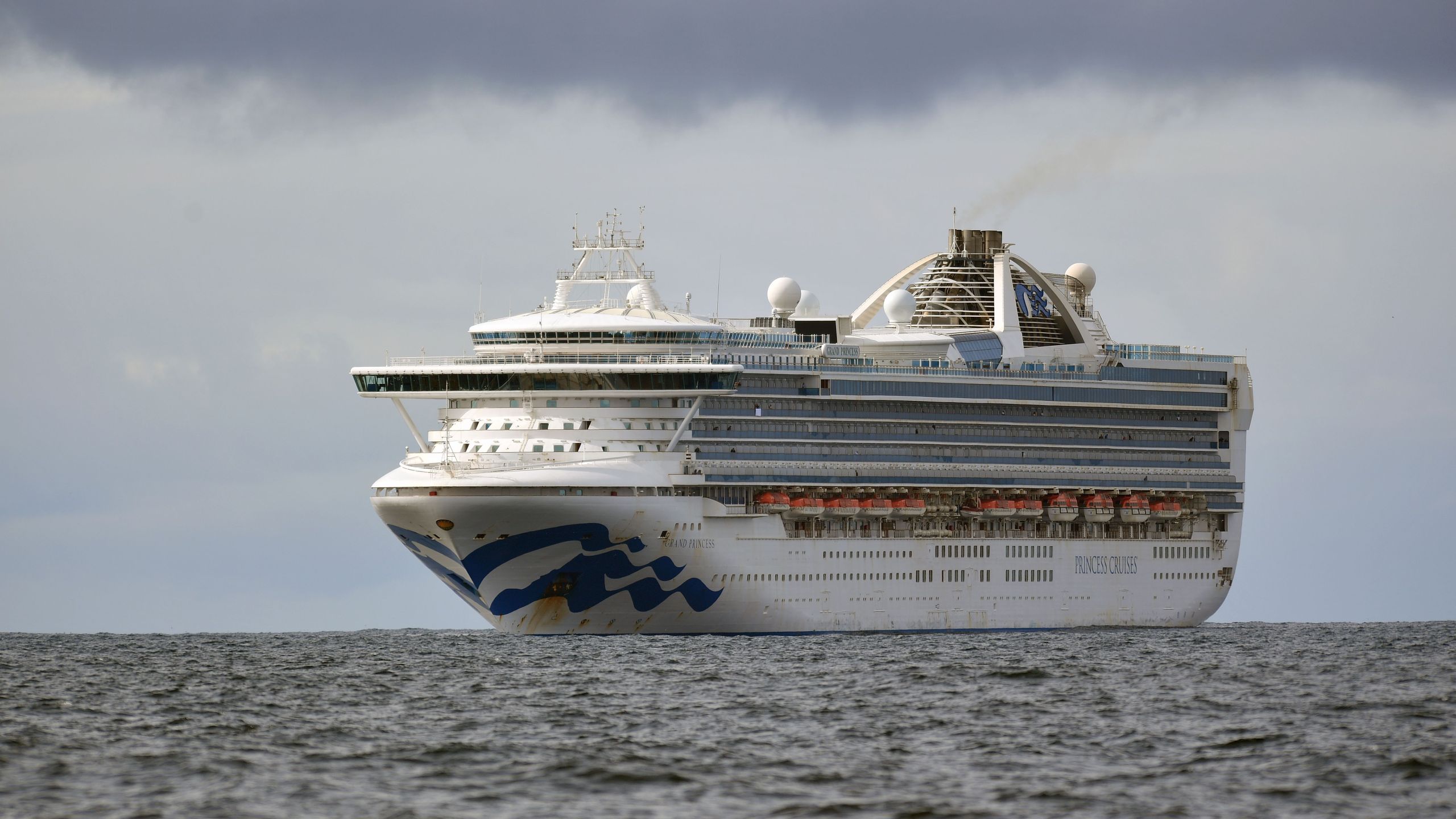 People look out from aboard the Grand Princess cruise ship, operated by Princess Cruises, as it maintains a holding pattern about 25 miles off the coast of San Francisco, California on March 8, 2020. (JOSH EDELSON/AFP via Getty Images)