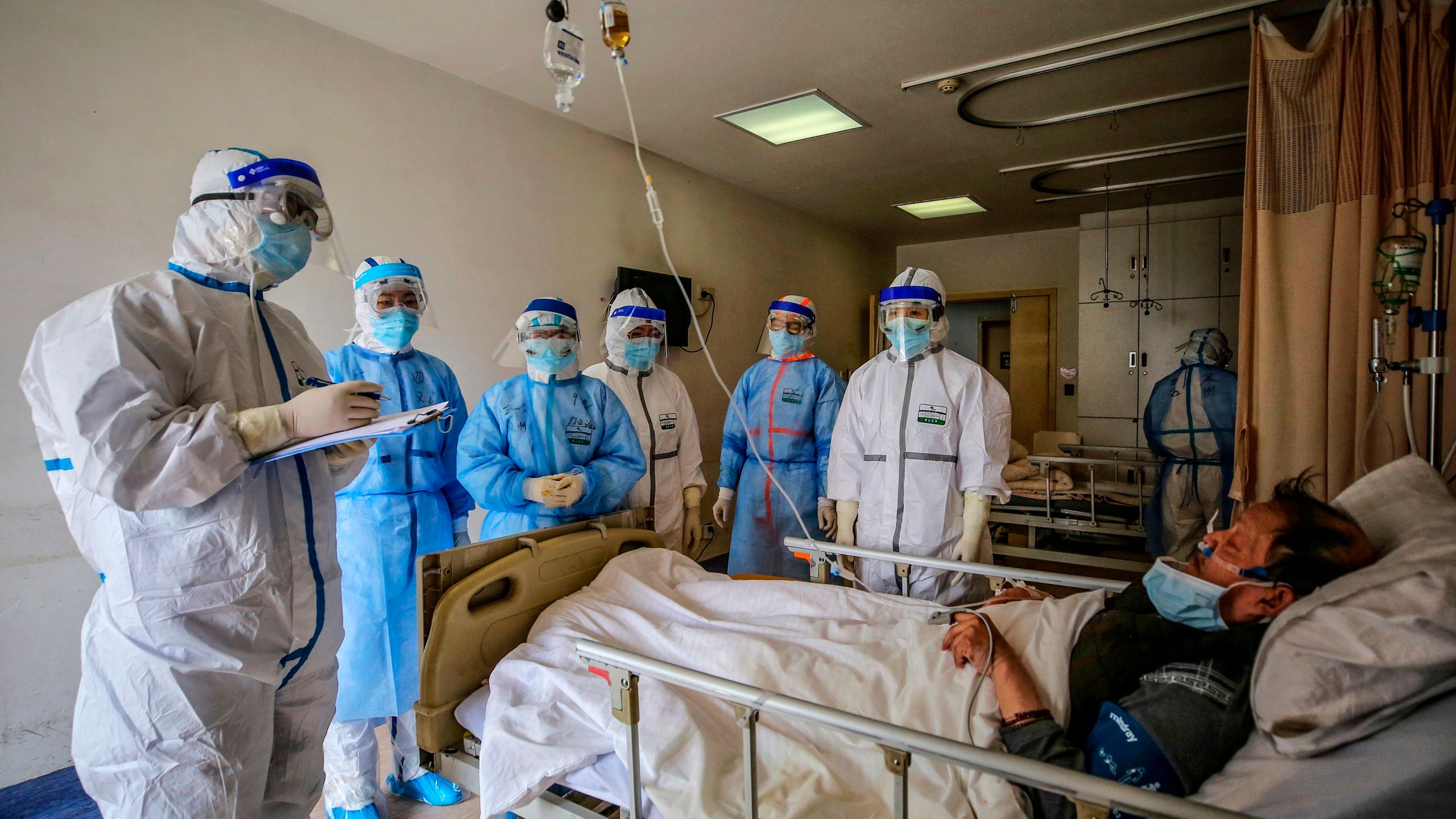 Medical staff speak with a COVID-19 patient at Red Cross Hospital in Wuhan, China, on March 10, 2020. (STR/AFP via Getty Images)