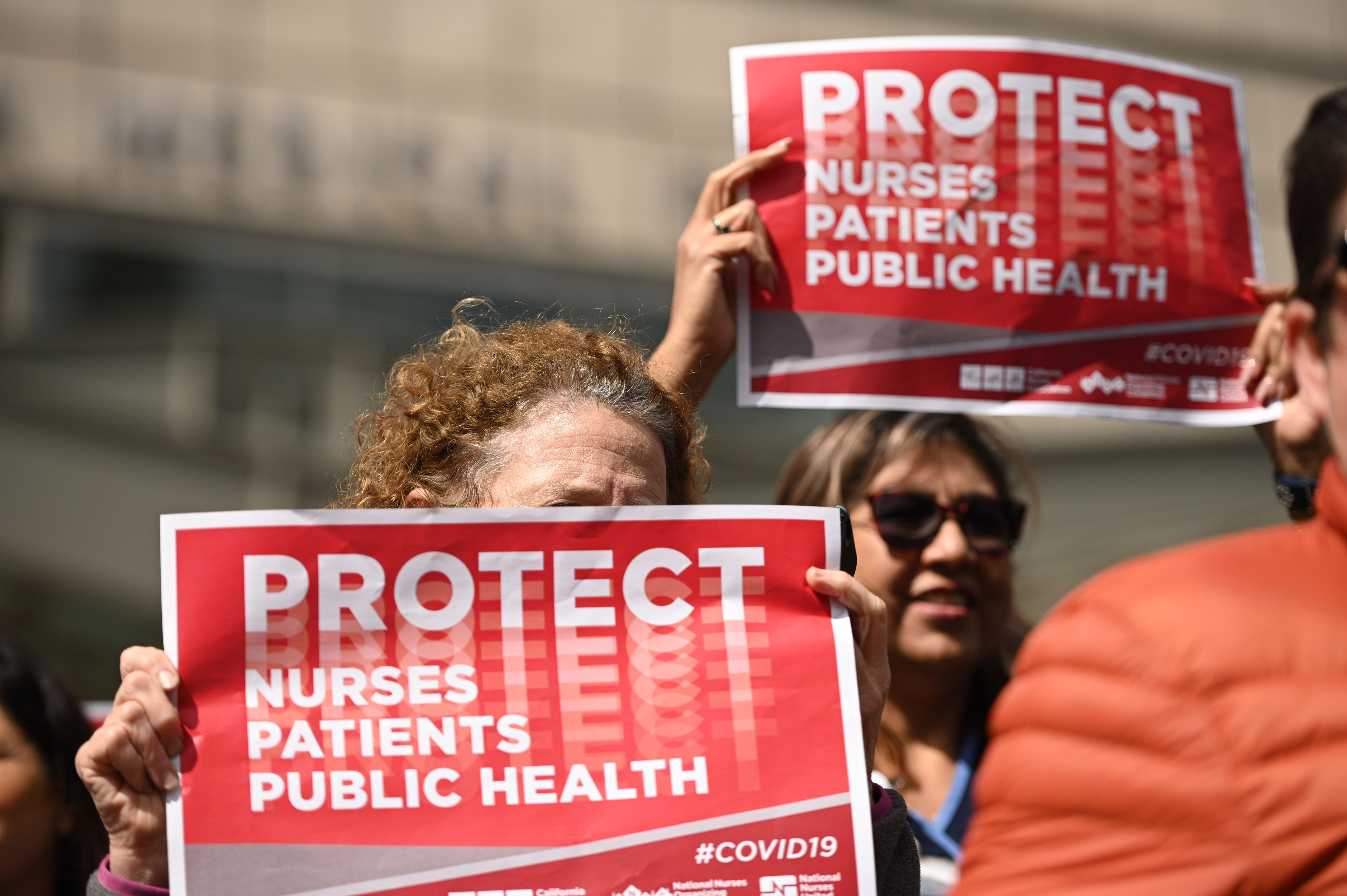 Nurses protest to oppose what they call the Center for Disease Control's weak response to the novel coronavirus, n March 11, 2020, outside the UCLA Medical Center in Los Angeles. (ROBYN BECK/AFP via Getty Images)