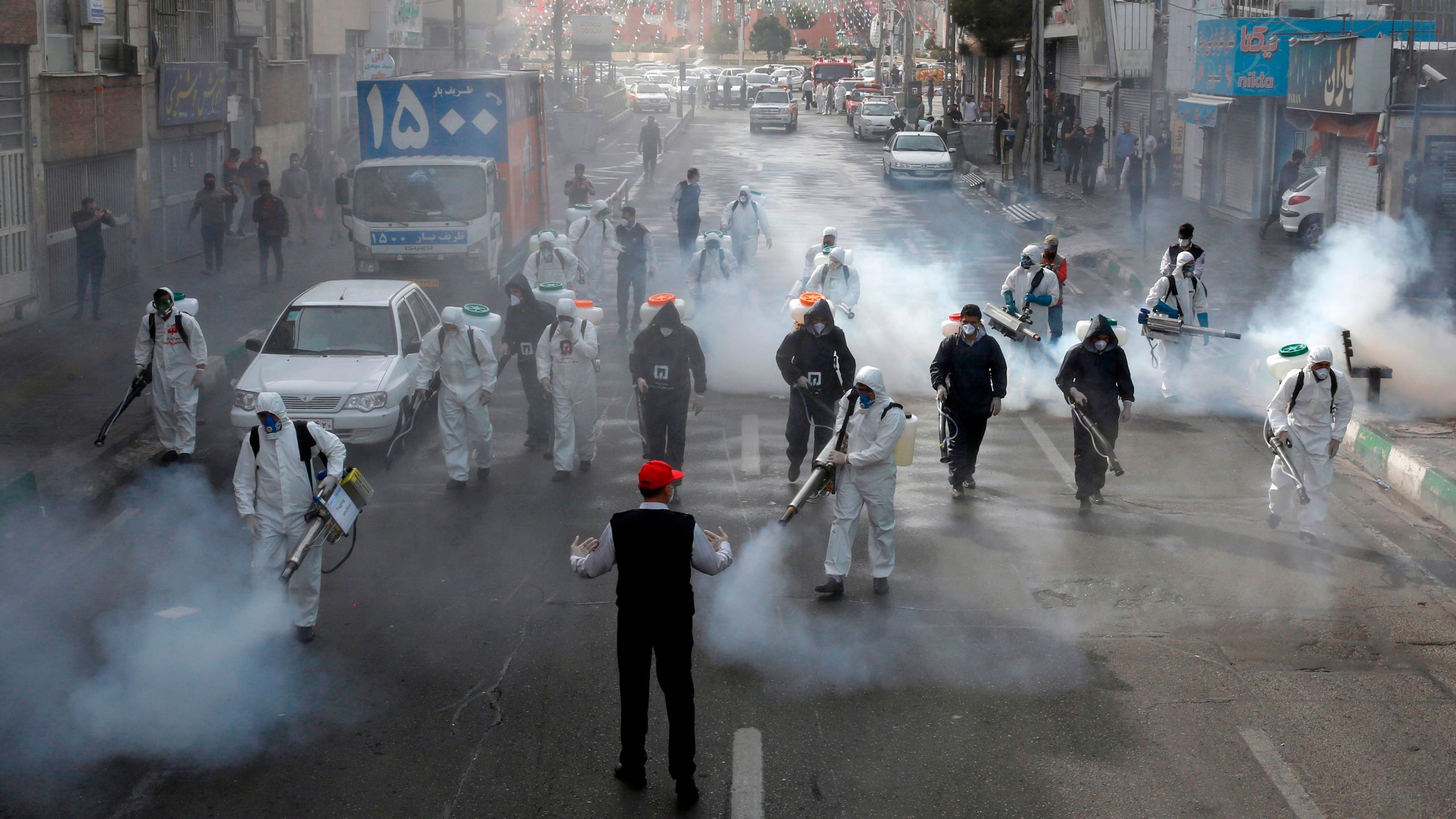 Iranian Firefighters disinfect streets in the capital Tehran in a bid to halt the wild spread of coronavirus on March 13 2020.(AFP via Getty Images)