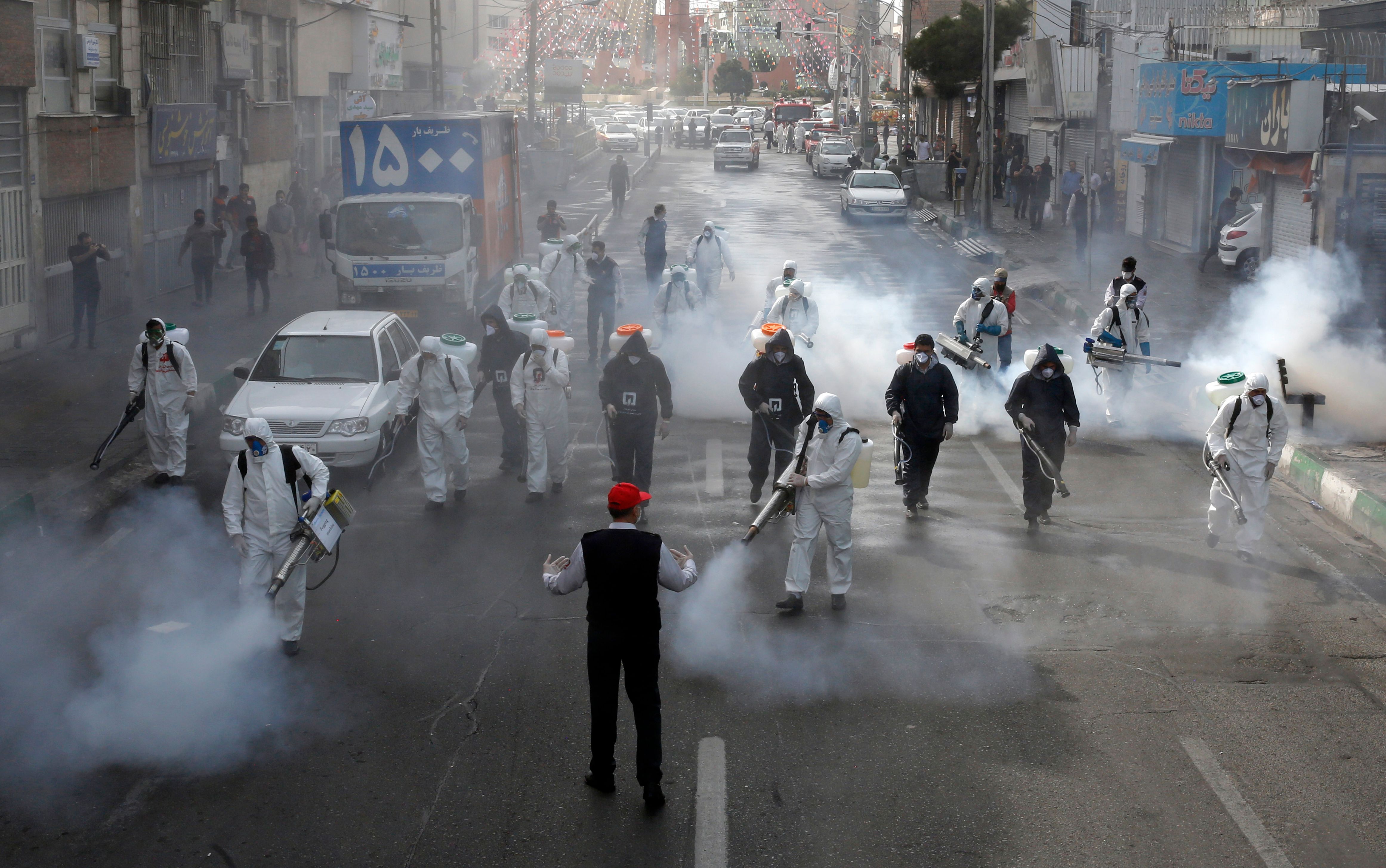 Iranian Firefighters disinfect streets in the capital Tehran in a bid to halt the wild spread of coronavirus on March 13 2020.(AFP via Getty Images)