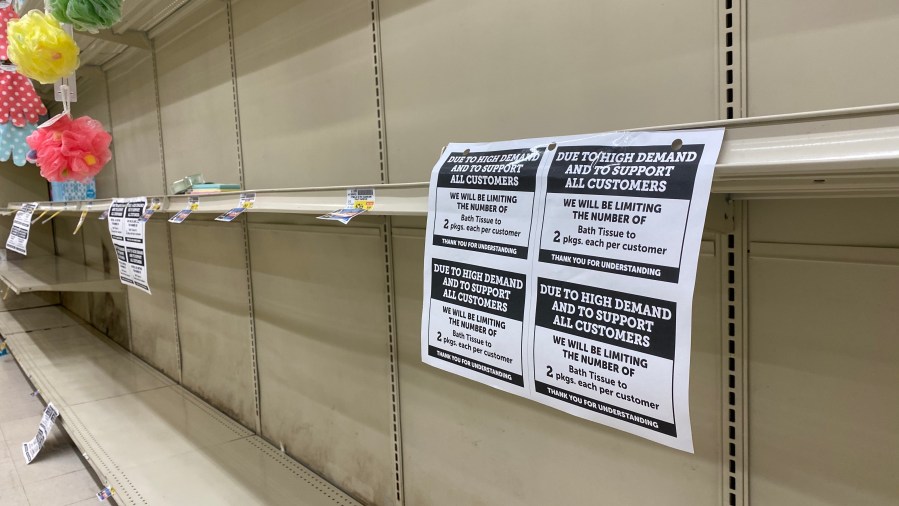 A sign is seen near an empty shelf for bath tissue in a supermarket in Culver City on March 12, 2020. (CHRIS DELMAS/AFP via Getty Images)