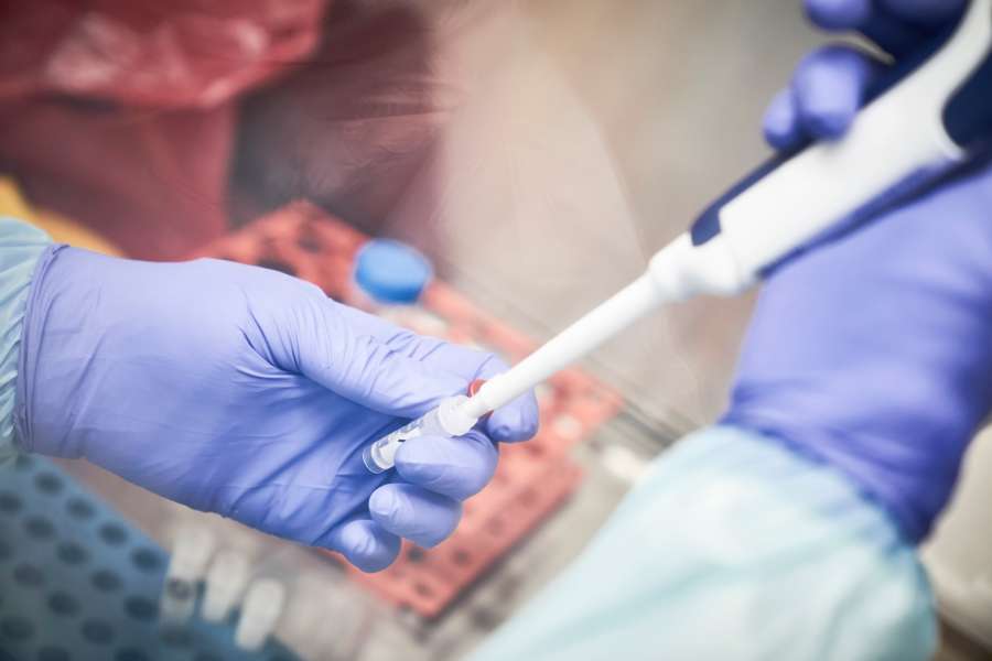 A researcher conducts a COVID-19 coronavirus test in this file photo from March 19, 2020. (Credit: Michele Cattani / AFP / Getty Images)