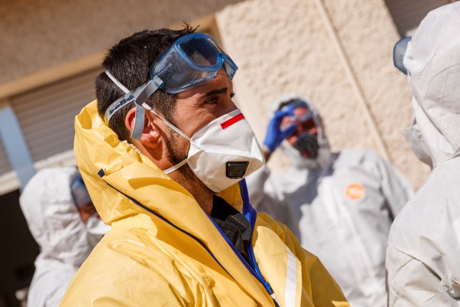 Members of the Military Emergencies Unit (UME) carry out a general disinfection at the Apanid residence for people with physical and intellectual disabilities of all ages in the Getafe suburb of Madrid on March 25, 2020, amid a national lockdown to fight the spread of the COVID-19 coronavirus. (BALDESCA SAMPER/AFP via Getty Images)