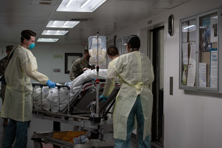 In this handout released by the U.S. Navy, Sailors assigned to the hospital ship USNS Mercy transport the first patient from Los Angeles medical facilities March 29, 2020. Mercy was deployed in support of the nation's COVID-19 response efforts, and will serve as a referral hospital for non-COVID-19 patients currently admitted to shore-based hospitals. This allows other hospitals to focus their efforts on COVID-19 cases. (U.S. Navy via Getty Images)