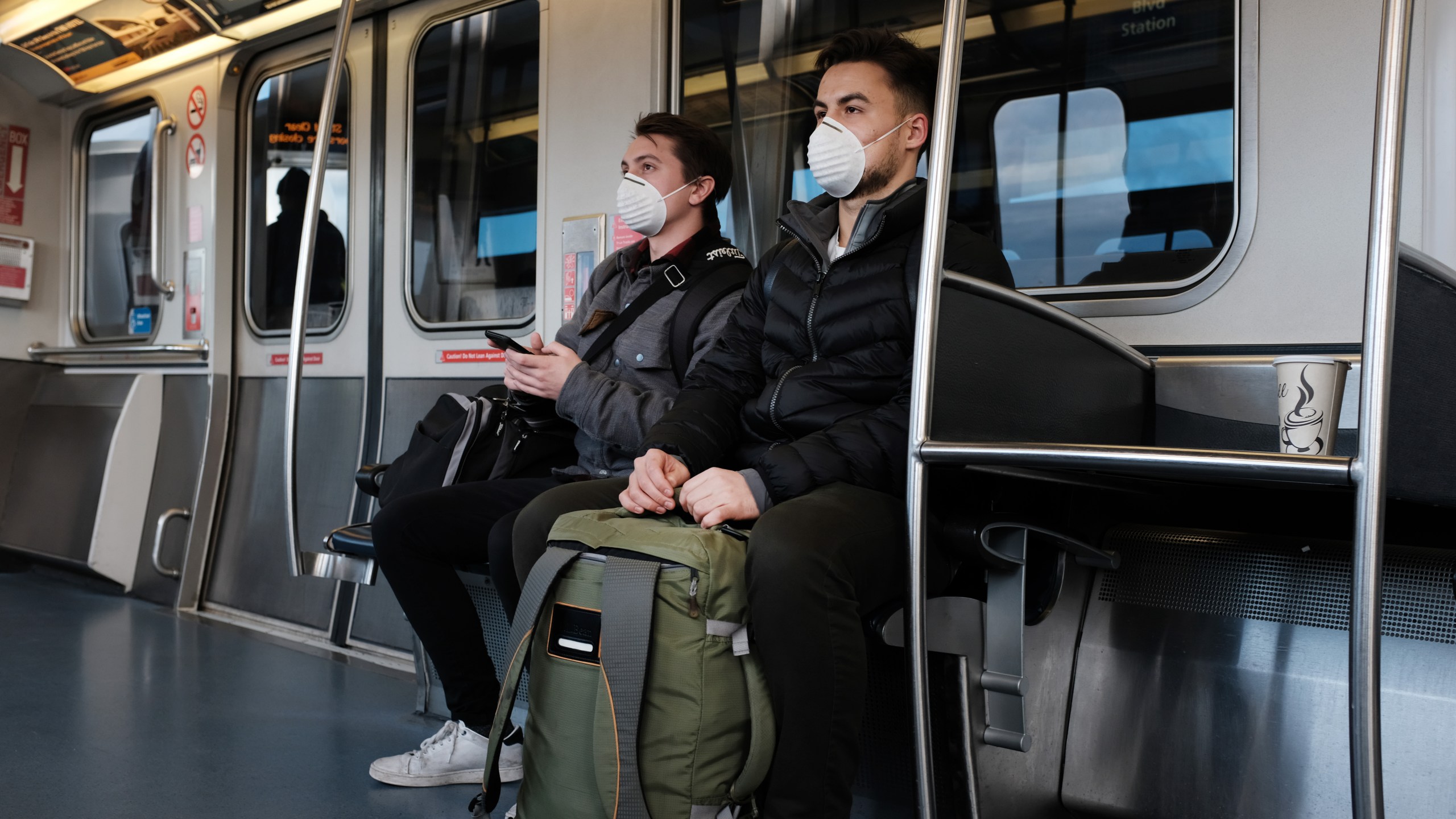 People wear medical face masks on the AirTrain headed to John F. Kennedy Airport in New York City on March 7, 2020, as concern over the coronavirus grows. (Spencer Platt/Getty Images)