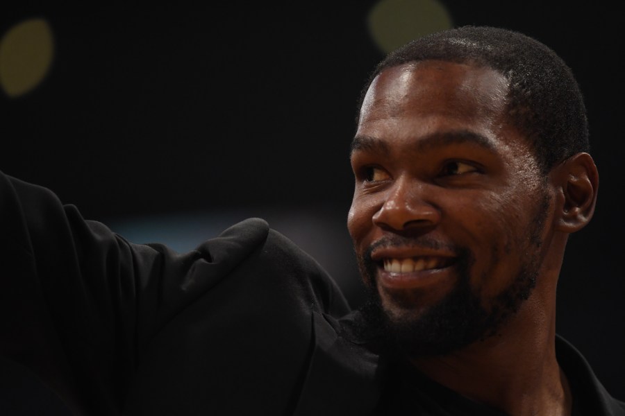 Kevin Durant of the Brooklyn Nets, sidelined by injury, smiles during a game against the Los Angeles Lakers at Staples Center on March 10, 2020. (Credit: Harry How / Getty Images)