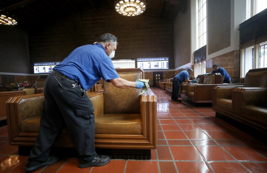 Seats in a waiting area are cleaned by custodial staff at Union Station on March 13, 2020 in Los Angeles. (Mario Tama/Getty Images)