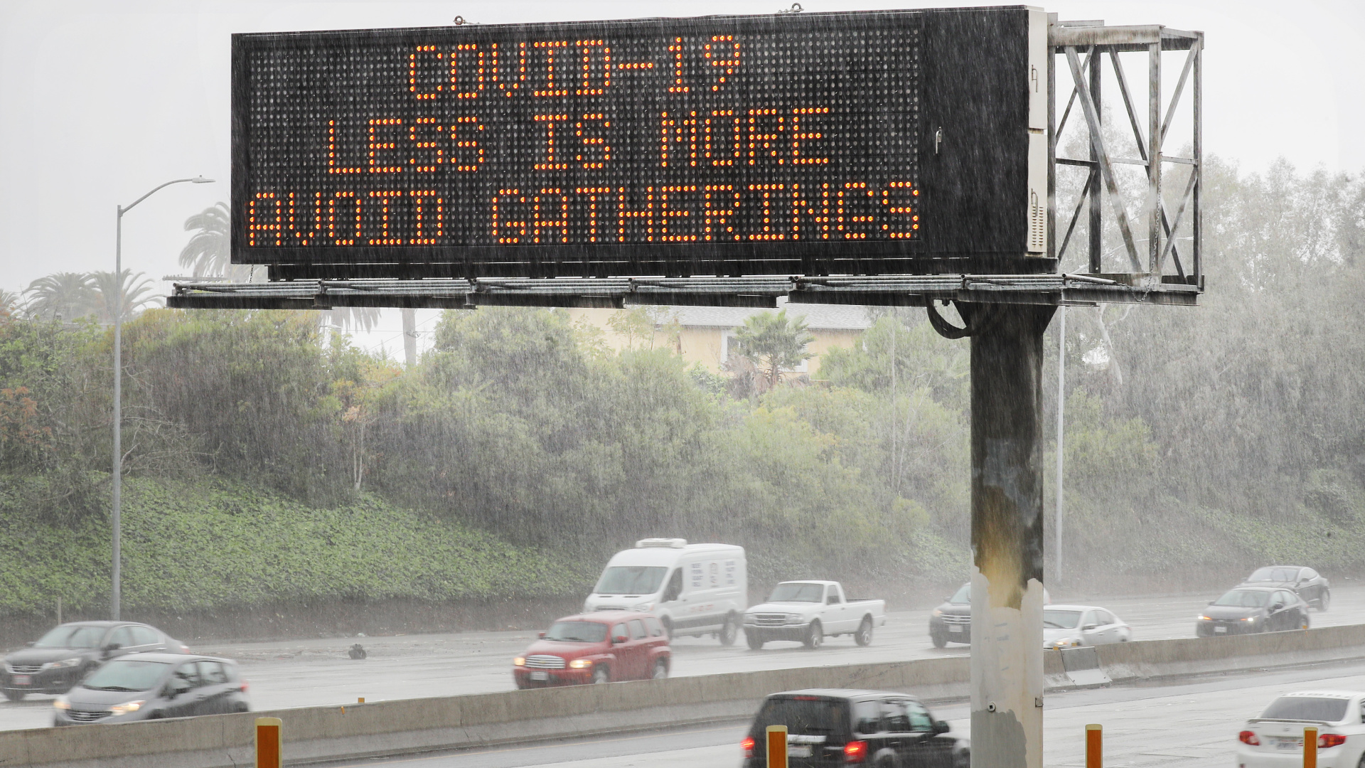 An electronic sign reads 'COVID-19 Less Is More Avoid Gatherings' along the I-10 Freeway on March 14, 2020, in Los Angeles. (Mario Tama/Getty Images)