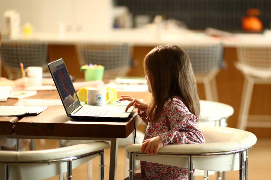 A kindergartener does schoolwork at her home on March 18, 2020, in San Anselmo, California.(Ezra Shaw/Getty Images)