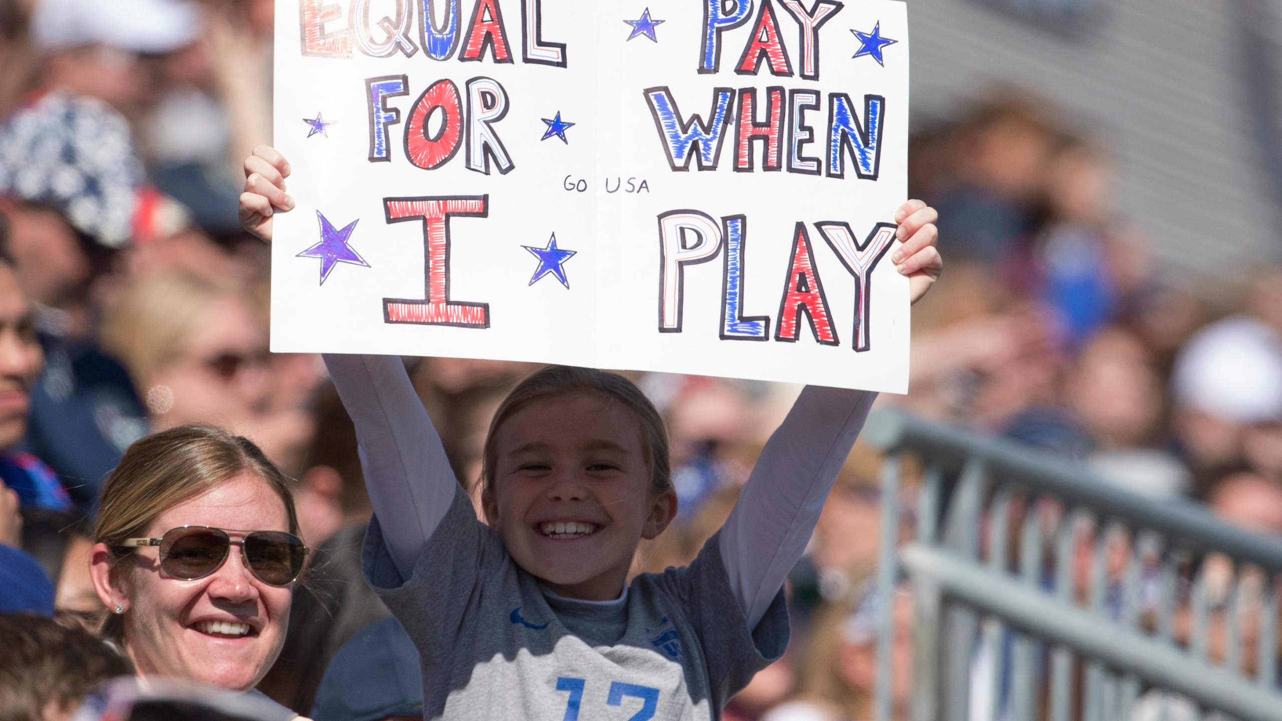 A fan of the United States holds a sign that reads, "Equal pay for when I play" during the game against Colombia at Talen Energy Stadium on April 10, 2016, in Chester, Pennsylvania. (Mitchell Leff/Getty Images)