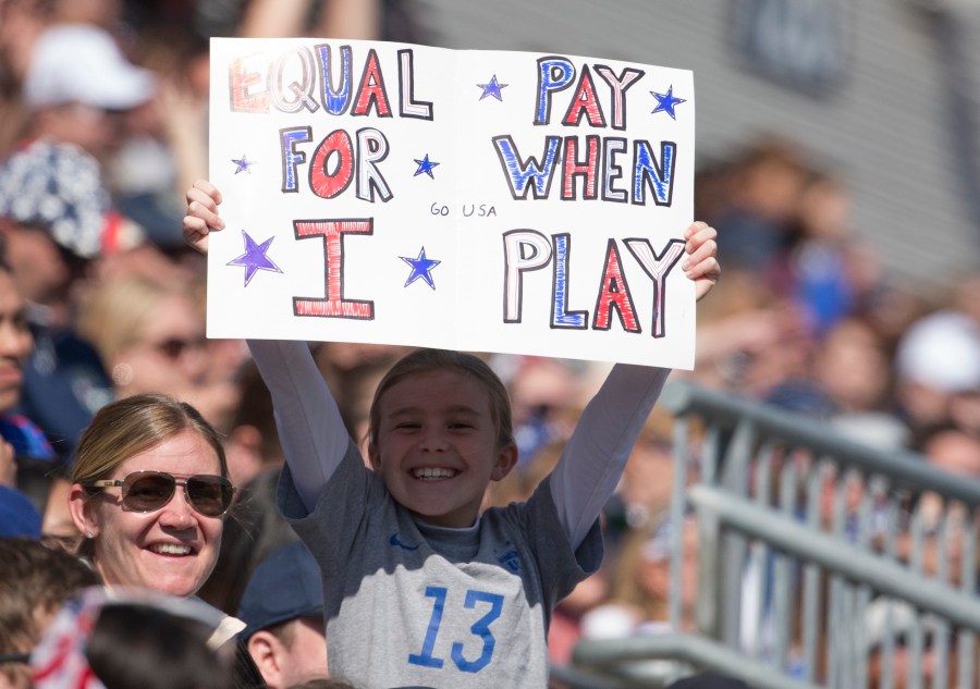 A fan of the United States holds a sign that reads, "Equal pay for when I play" during the game against Colombia at Talen Energy Stadium on April 10, 2016, in Chester, Pennsylvania. (Mitchell Leff/Getty Images)