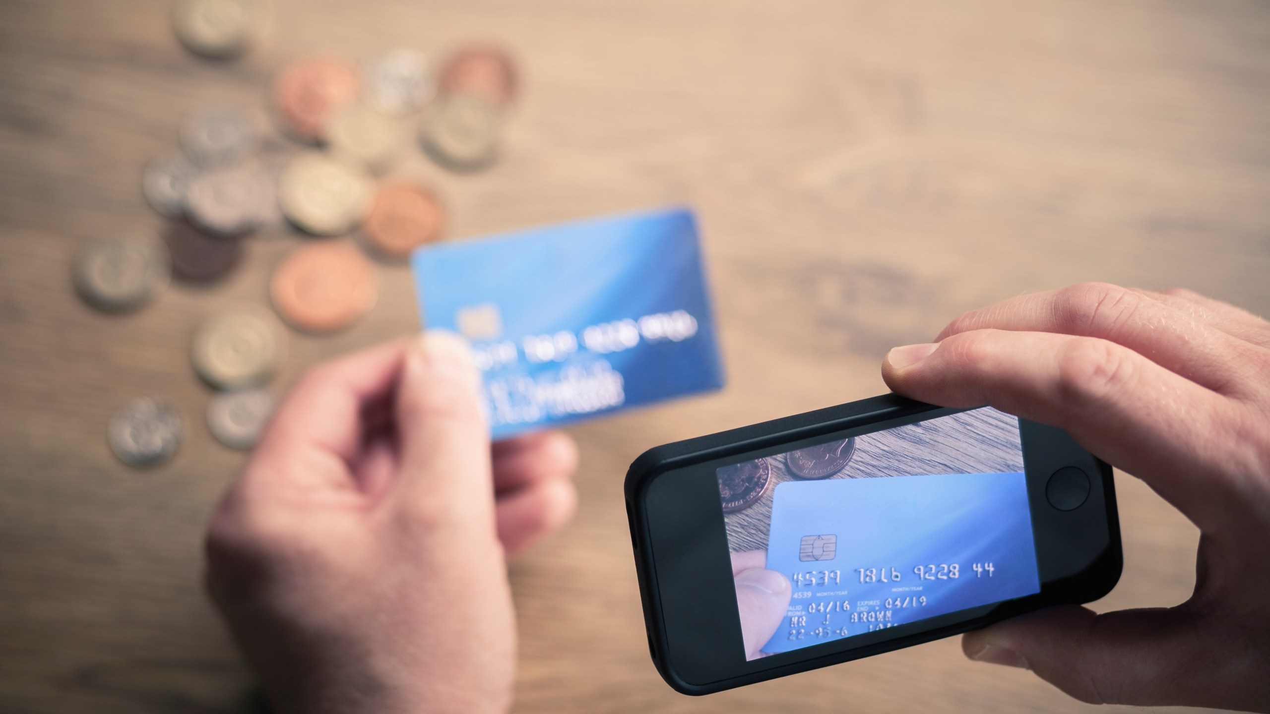 A man photographs a credit card in this undated file photo. (Getty Images)