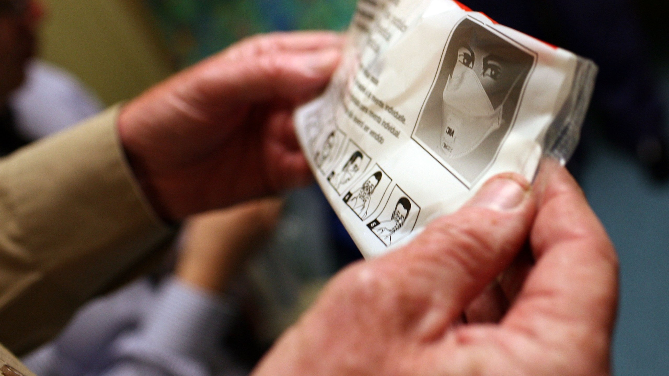 A hospital worker holds up the instructions for using an N95 respiratory mask in a file photo. (Justin Sullivan/Getty Images)