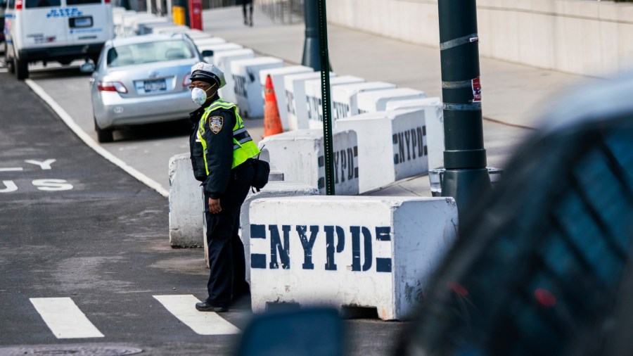 A New York Police officer wears a face mask as he directs traffic on a local street on March 27, 2020, in New York City. (Eduardo Munoz Alvarez/Getty Images)