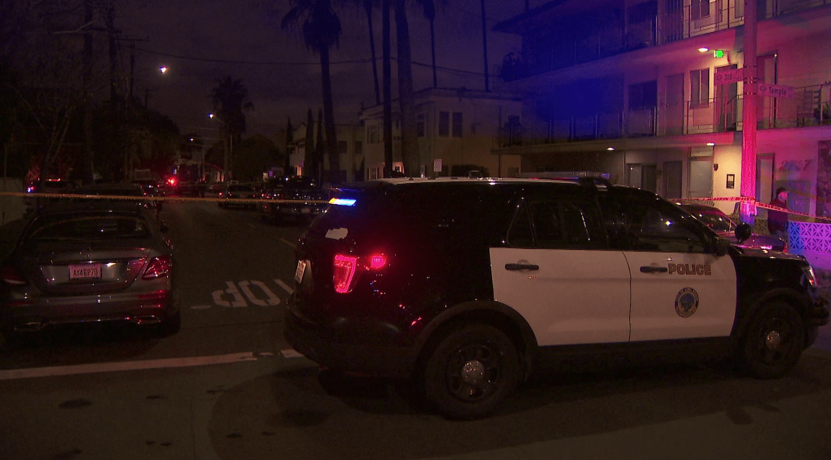 A Long Beach police vehicle is seen in the 200 block of Molino Avenue where an officer fatally shot a woman police said tried to stab her mother on March 15, 2020. (KTLA)