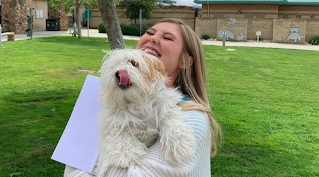 Amy Hutto poses with her new dog in this photo released by Riverside County Animal Services on March 20, 2020.