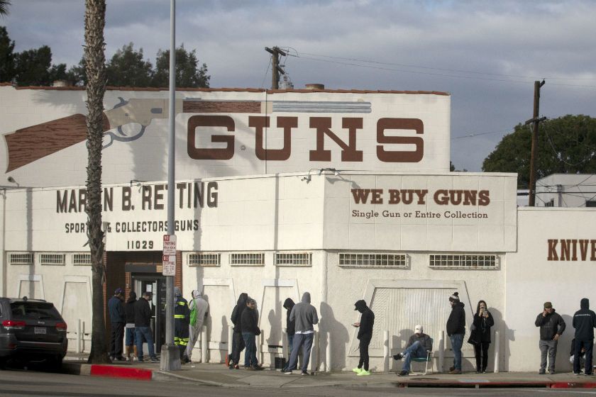 A line at the Martin B. Retting gun store in Culver City extends out the door and around the corner on March 22, 2020. (Francine Orr / Los Angeles Times)