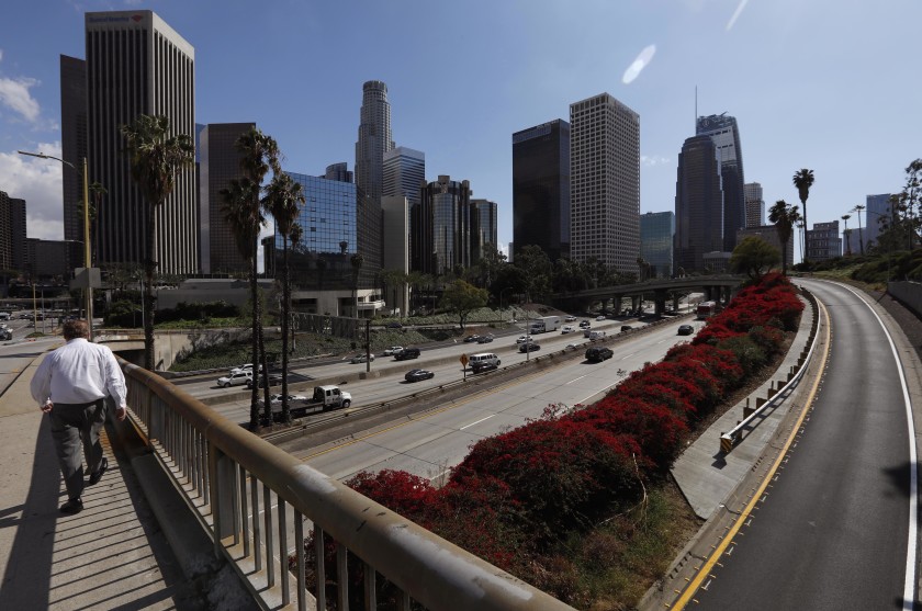 The 110 Freeway through downtown had noticeably lighter traffic on the afternoon of March 11, 2020.(Genaro Molina / Los Angeles Times)