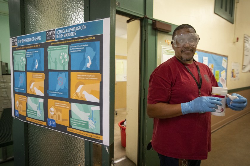 Assistant Plant Manager Tracy Westfield cleans John Burroughs Middle School in Hancock Park on March 10, 2020. (Credit: Francine Orr / Los Angeles Times )