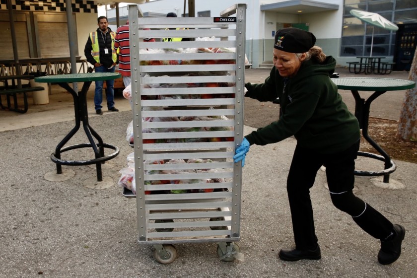 Gloria Murrietta, who works in food services for the L.A. school district, prepares meals for distribution to community members at Baldwin Hills' Dorsey High School in this undated photo. (Credit: Irfan Khan / Los Angeles Times)