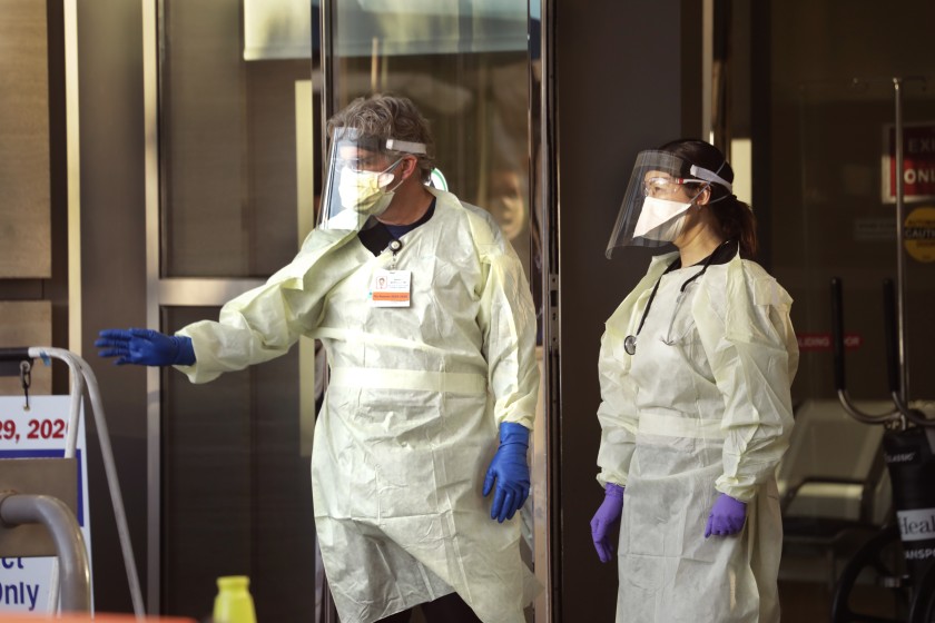 Workers stand outside UCLA Medical Center in March 2020. (Credit: Carolyn Cole / Los Angeles Times)