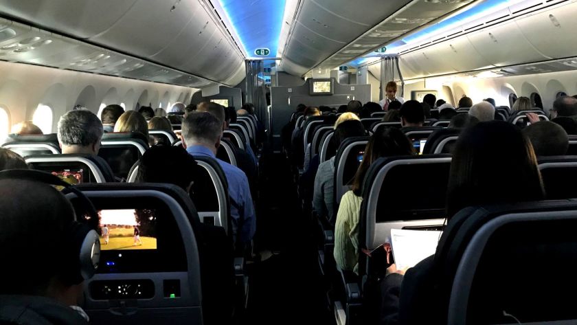 Airline passengers on a recent flight.(Jerome Adamstein / Los Angeles Times)