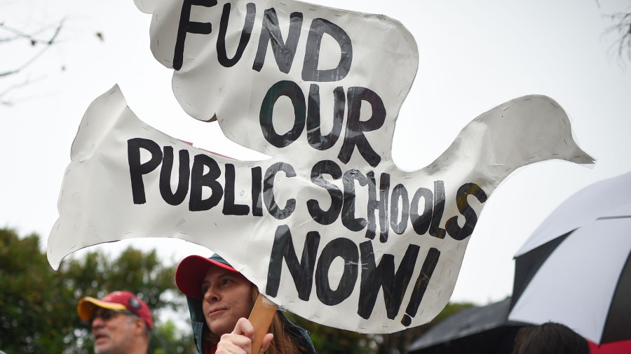 Striking teachers are joined by parents and students on the picket line outside Dahlia Heights Elementary School in the Eagle Rock section of Los Angeles during a teachers strike on Jan. 16, 2019. (ROBYN BECK/AFP via Getty Images)