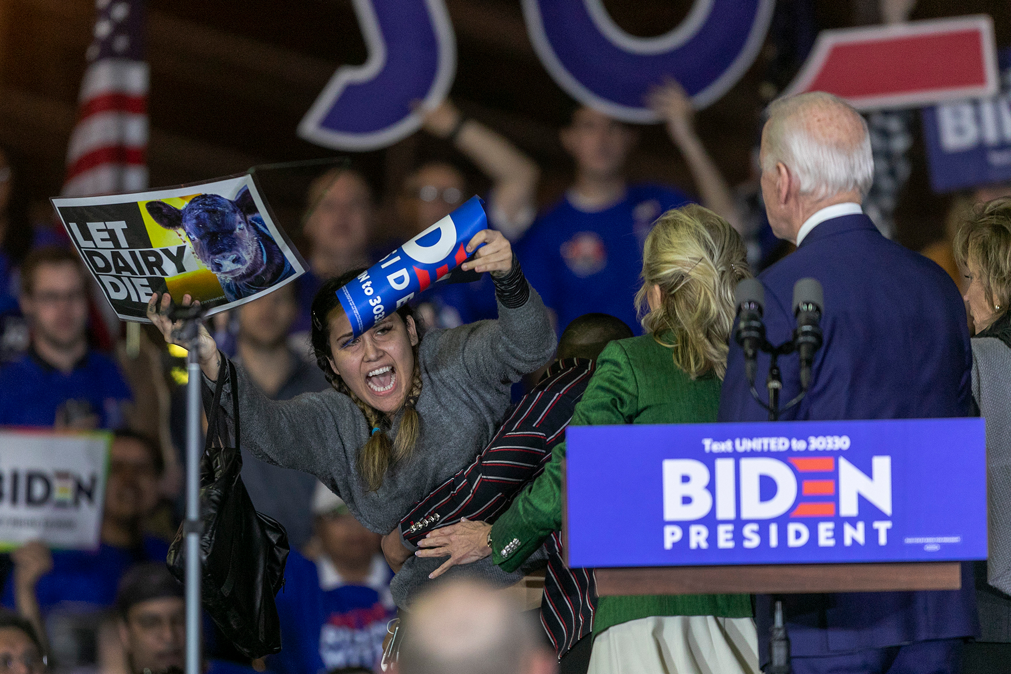 A woman charges the stage as Democratic presidential candidate former Vice President Joe Biden speaks at a Super Tuesday event at Baldwin Hills Recreation Center on March 3, 2020 in Los Angeles. (David McNew/Getty Images)