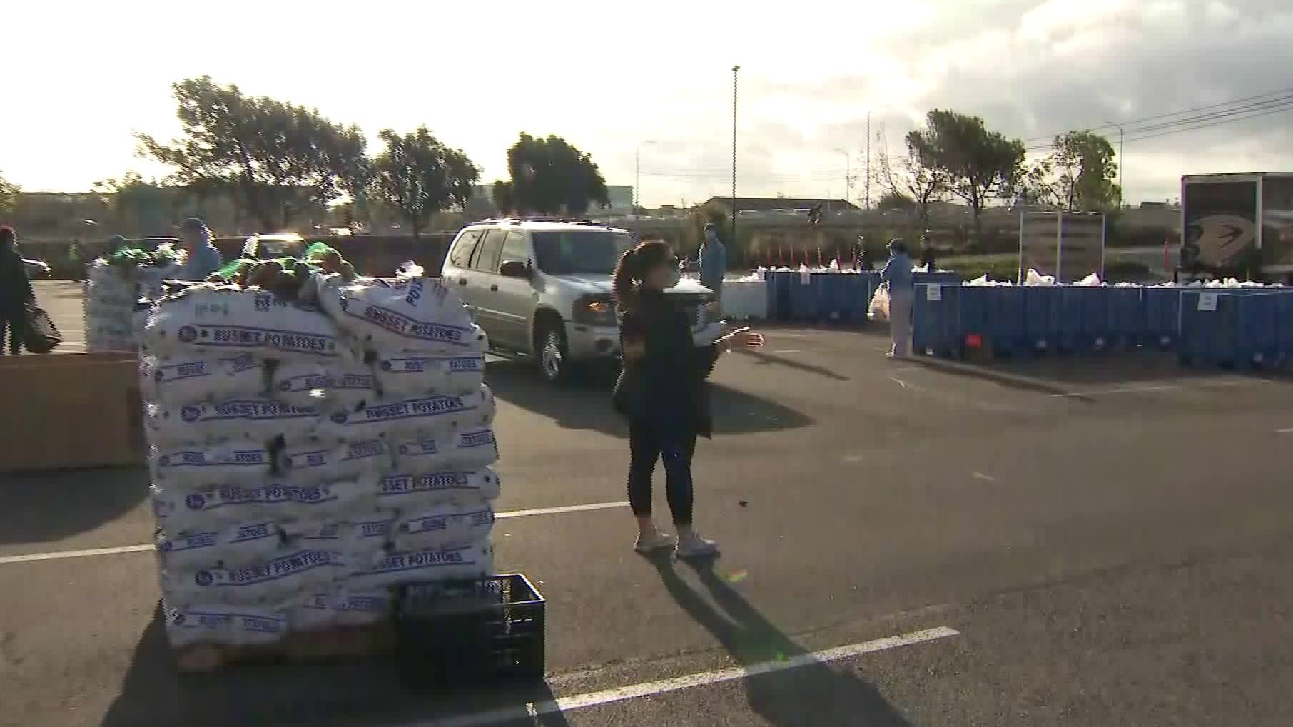 Volunteers hand out food at a drive-thru food bank at Honda Center on March, 21, 2020. (KTLA)