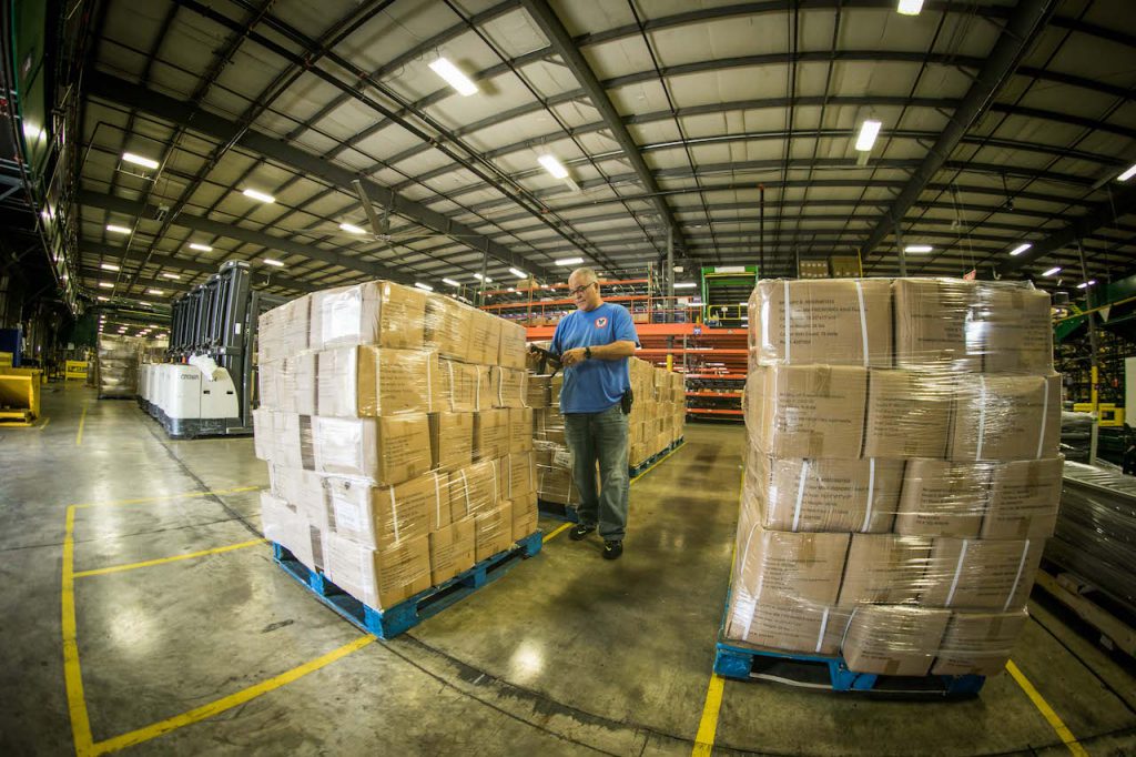 A man stands alongside boxes of medical supplies in this photo posted on the Disney Parks website on April 1, 2020.