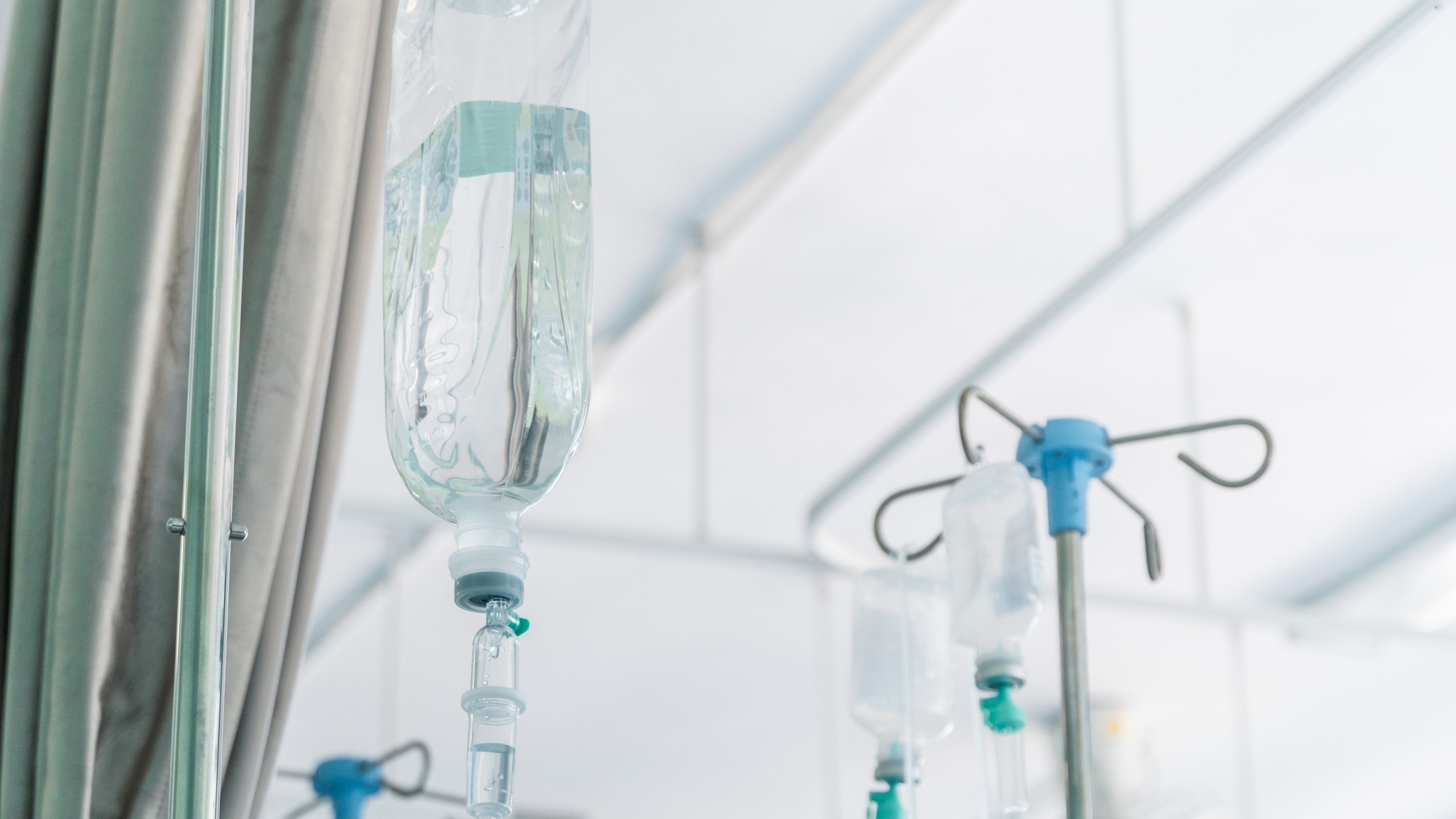 A saline drip hangs from a wall in a hospital room. (Getty Images)