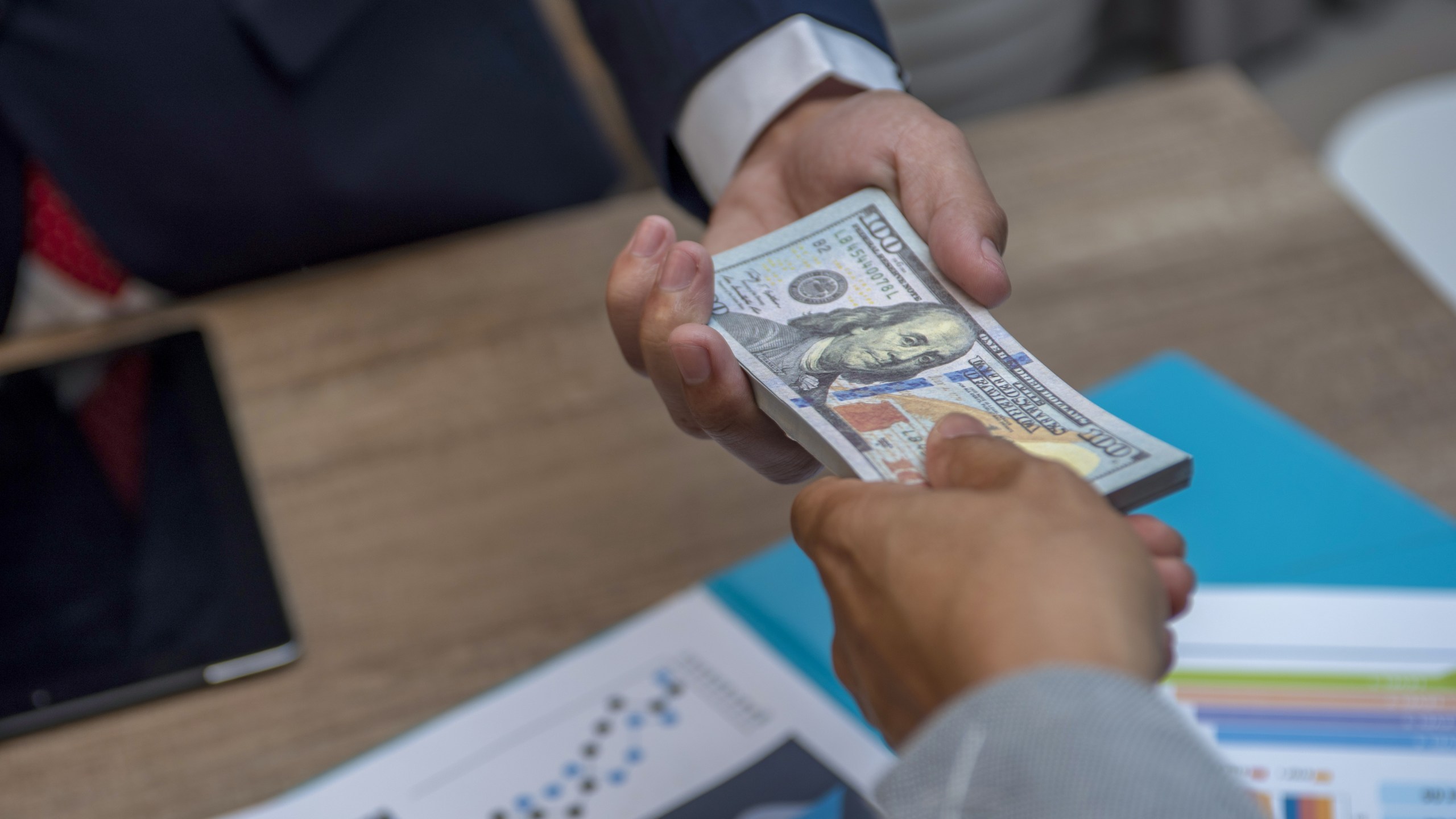 An exchange of cash is seen in this undated file photo. (Getty Images)