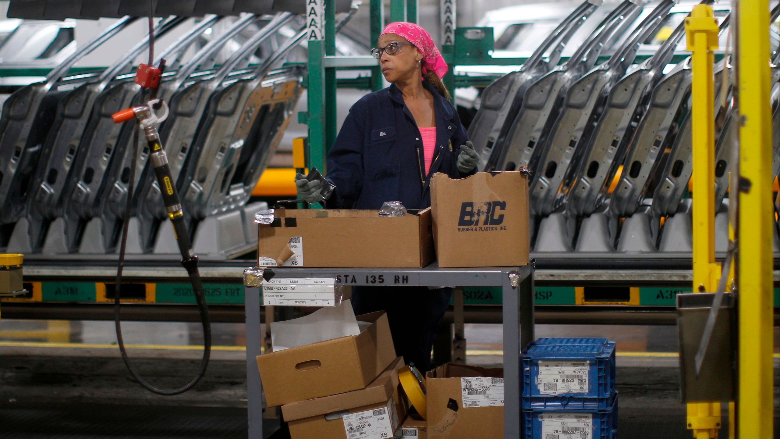 Workers assemble cars at the newly renovated Ford's Assembly Plant in Chicago, June 24, 2019. (JIM YOUNG/AFP via Getty Images)