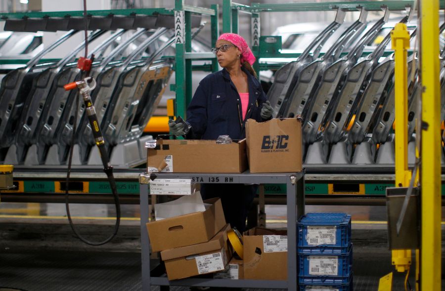 Workers assemble cars at the newly renovated Ford's Assembly Plant in Chicago, June 24, 2019. (JIM YOUNG/AFP via Getty Images)