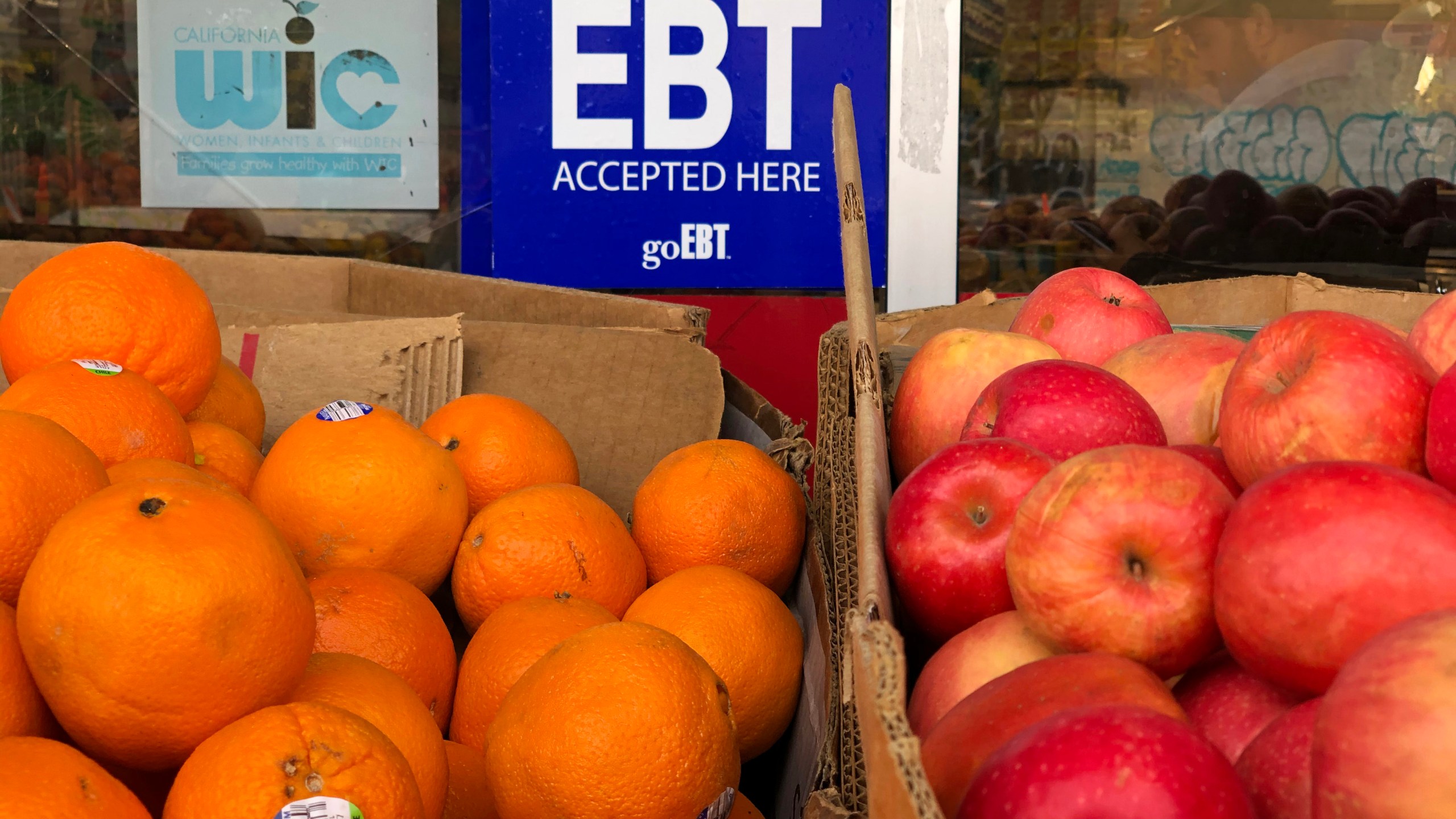 A sign noting the acceptance of electronic benefit transfer (EBT) cards that are used by state welfare departments to issue benefits is displayed at a grocery store on Dec. 4, 2019, in Oakland, Calif. (Justin Sullivan/Getty Images)