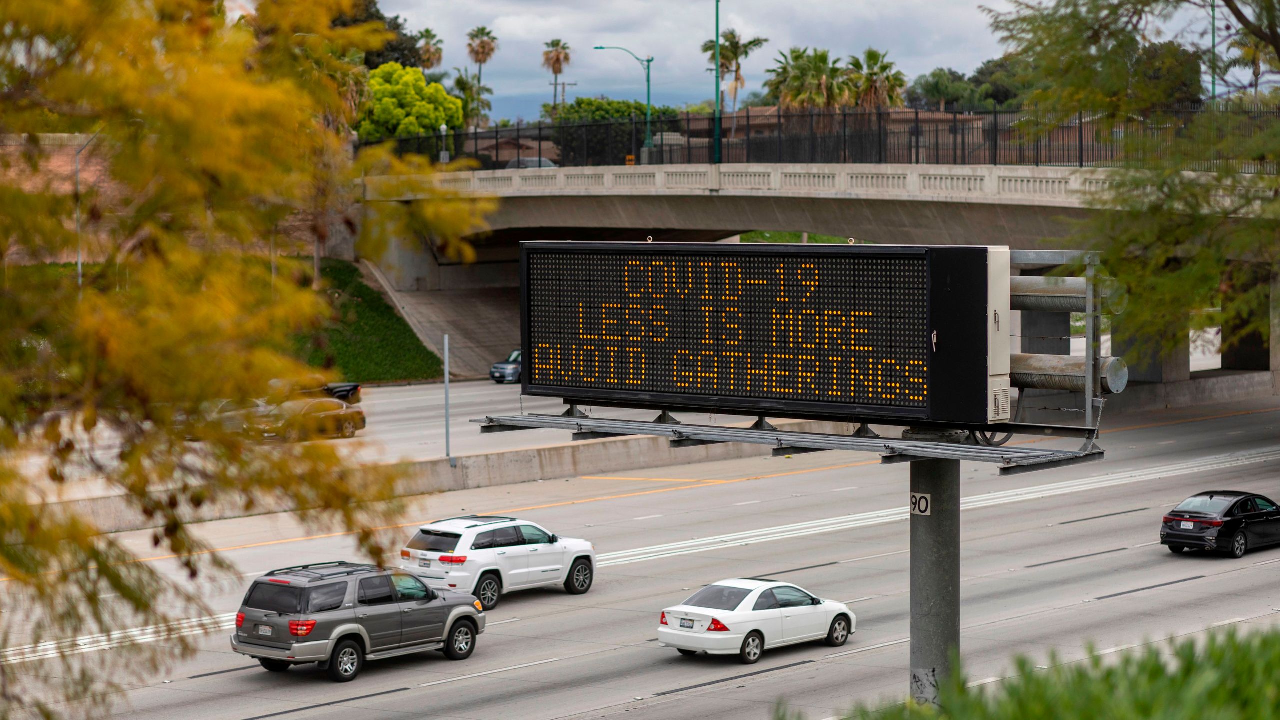 A Caltrans sign warns motorists on the 5 Freeway in Anaheim to not gather in crowds as the threat of coronavirus disease increases on March 14, 2020. (DAVID MCNEW/AFP via Getty Images)