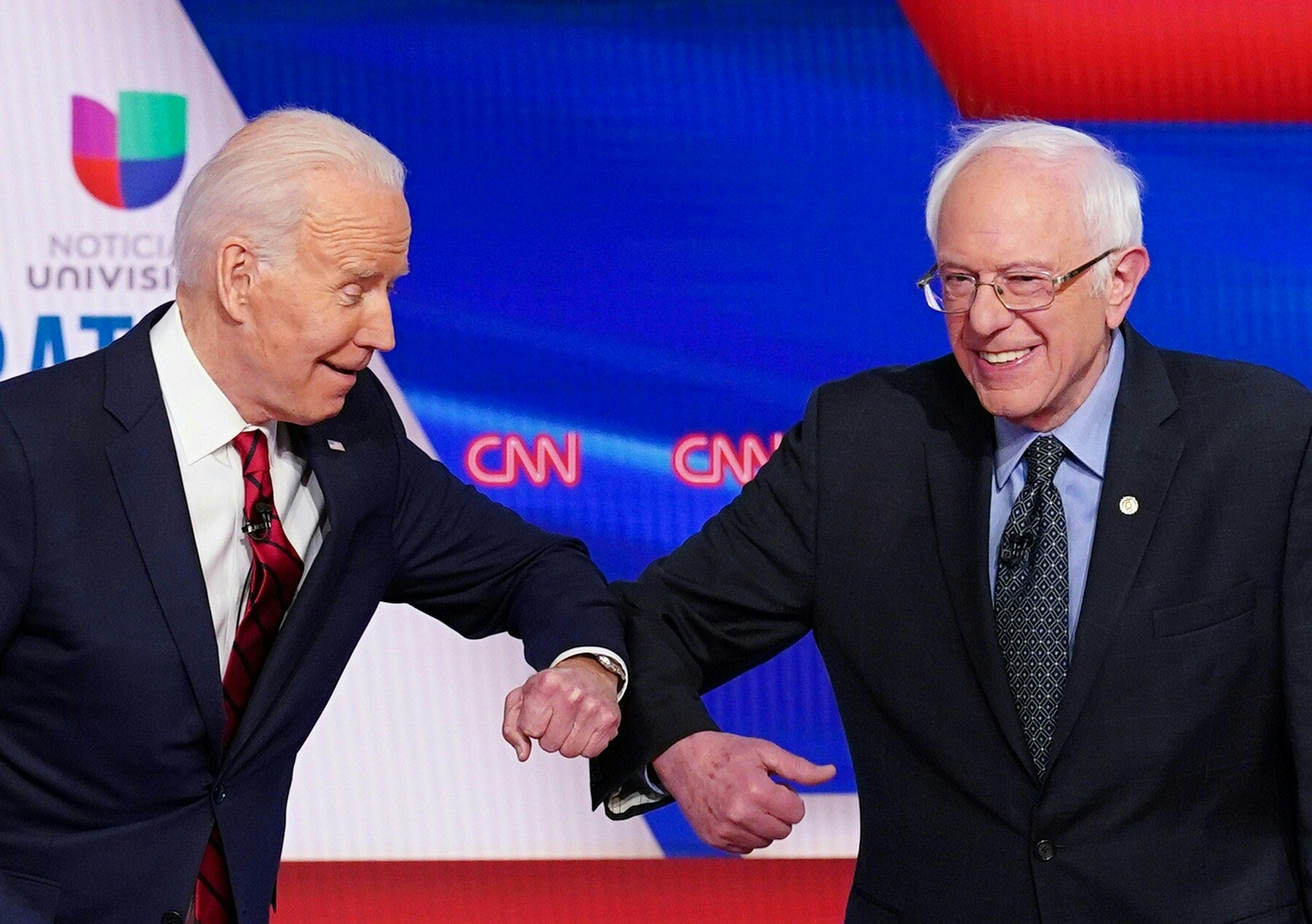 Joe Biden and Bernie Sanders greet each other with an elbow bump as they arrive for the 11th Democratic Party 2020 presidential debate in a CNN Washington Bureau studio on March 15, 2020. (MANDEL NGAN/AFP via Getty Images)