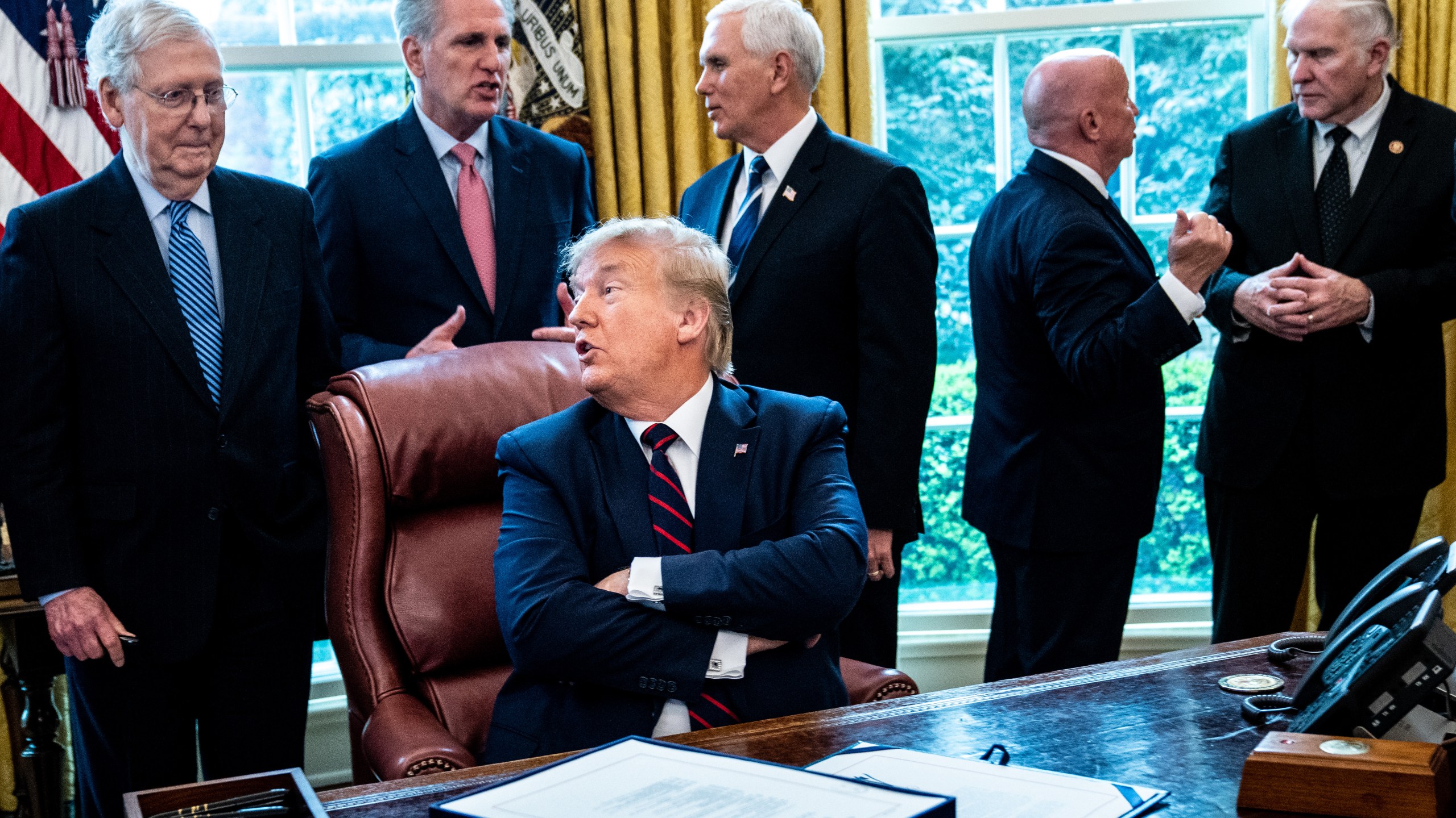 President Donald Trump speaks with Senate Majority Leader Mitch McConnell during a bill signing ceremony for the CARES Act in the Oval Office of the White House on March 27, 2020, in Washington, DC. (Erin Schaff-Pool/Getty Images)