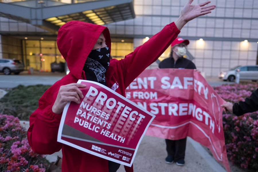 Nurses at UCLA Ronald Reagan Medical Center hold a vigil in Los Angeles on March 30, 2020. (RINGO CHIU/AFP via Getty Images)