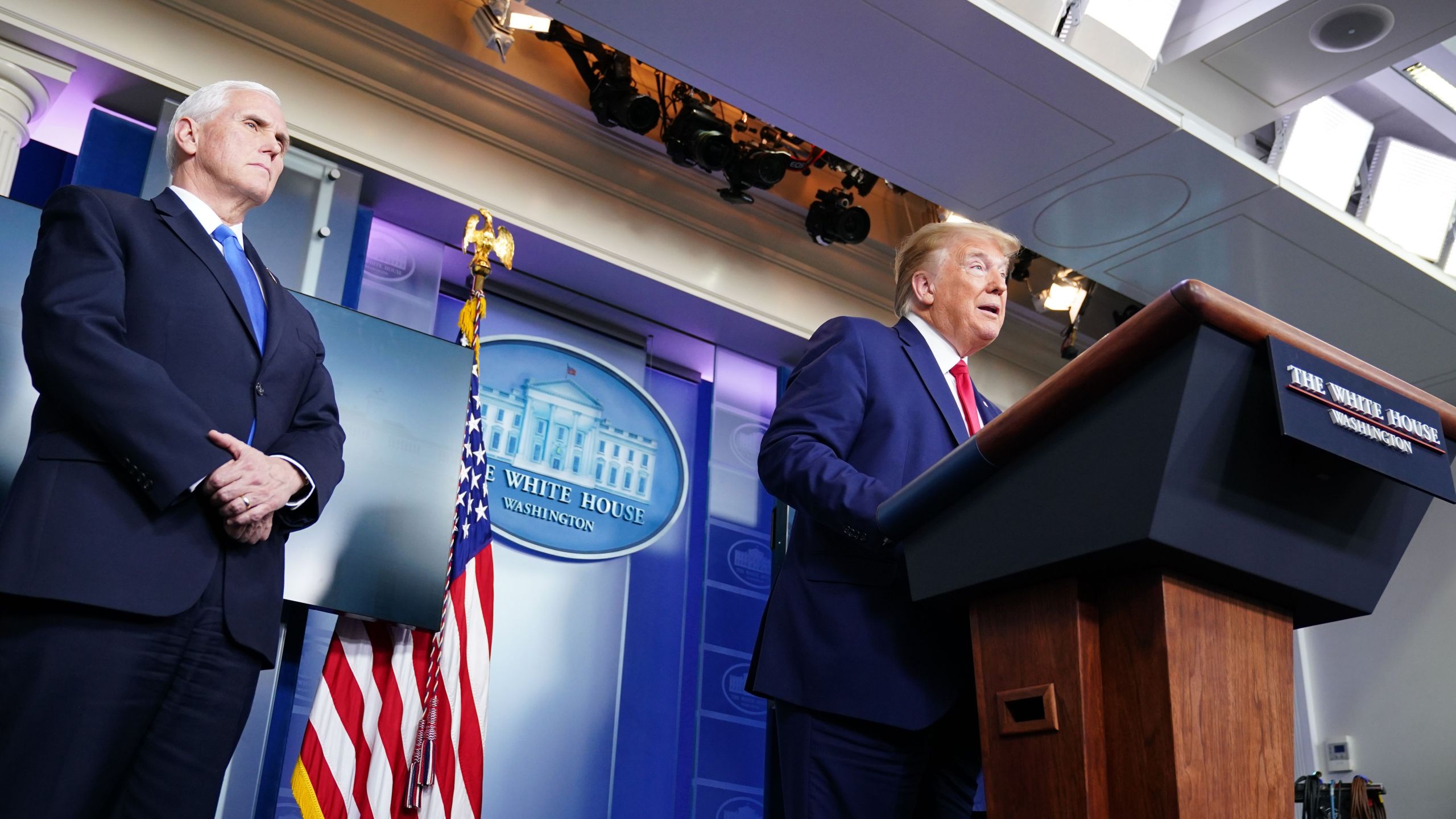 President Donald Trump speaks as Vice President Mike Pence looks on during the White House's daily briefing on the novel coronavirus on April 6, 2020. (Credit: Mandel Ngan / AFP / Getty Images)