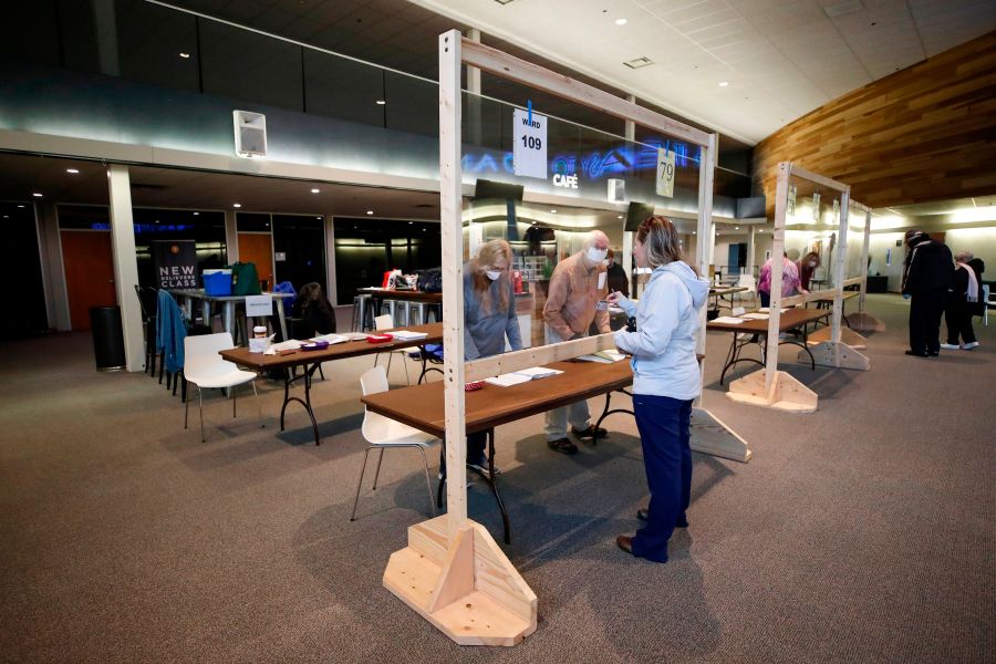 A woman checks in to cast her ballot in a presidential primary election at the Journey Church in Kenosha, Wisconsin, on April 7, 2020. (KAMIL KRZACZYNSKI/AFP via Getty Images)