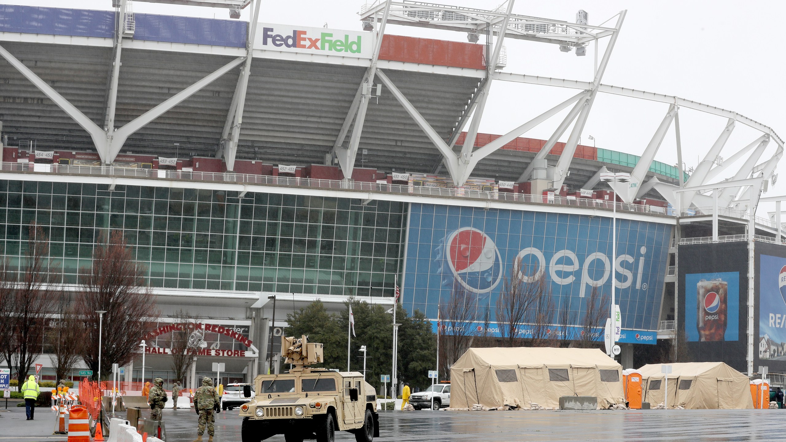 Tents, vehicles and other equipment from the Maryland National Guard occupy a section of parking lot on the south side of FedEX Field, home of the Washington Redskins, that officials said will become a clinic for health screenings in response to the global coronavirus pandemic March 23, 2020 in Landover, Maryland. (Chip Somodevilla/Getty Images)