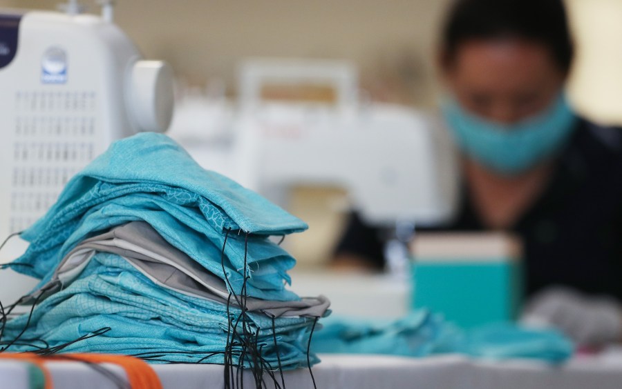 An employee from an L.A.-based shoe company makes masks to be donated to hospitals amid the coronavirus pandemic on March 31, 2020, in Culver City, California. (Mario Tama/Getty Images)