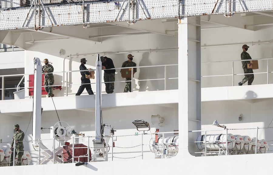 Military personnel wearing face masks work aboard the USNS Mercy hospital ship docked in the Port of Los Angeles amidst the coronavirus pandemic on April 15, 2020. (Credit: Mario Tama / Getty Images)